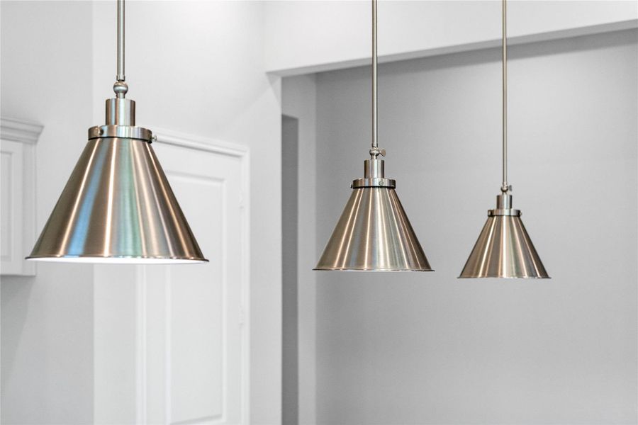 Illumination meets industrial chic with this striking trio of brushed nickel pendant lights. Illumination meets industrial chic with this striking trio of brushed nickel pendant lights.