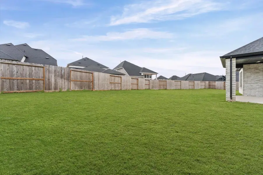 A clean, open backyard with room to make it your own — entertain, let the kids run, or start planning that outdoor kitchen.