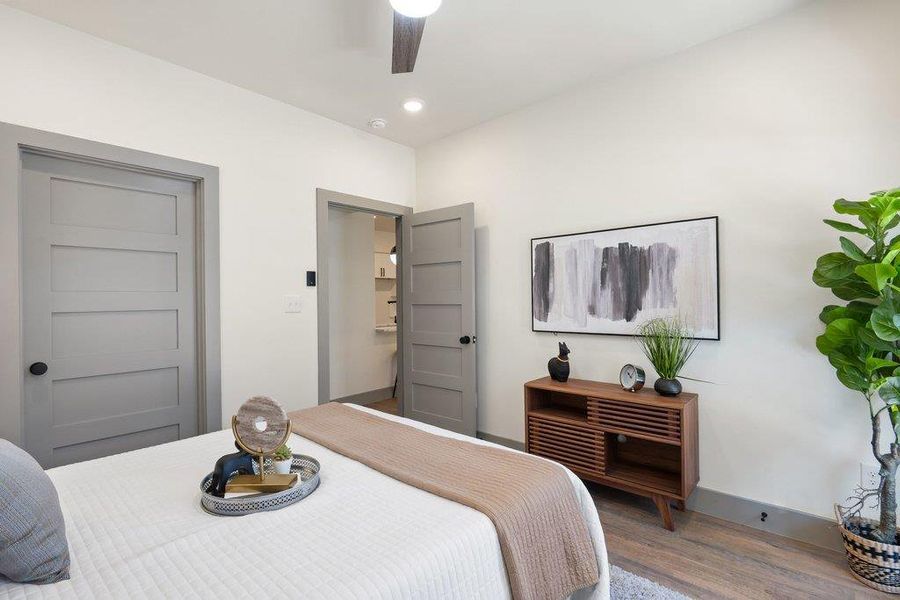 Bedroom with wood finished floors, a ceiling fan, and recessed lighting