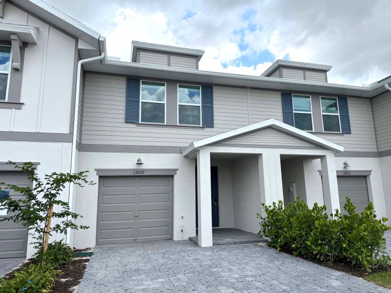 Front exterior of a new home in Meritage Homes at Central Park, Port St. Lucie, FL, highlighting curb appeal (Image 2). Front exterior of a new home in Meritage Homes at Central Park, Port St. Lucie, FL, highlighting curb appeal (Image 2).