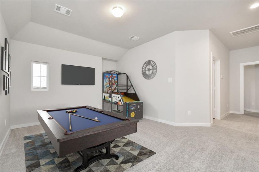 Come upstairs and enjoy a day of leisure in this fabulous game room! This is the perfect hangout spot or adult game room! Features plush carpet, high ceilings, custom paint and windows for plenty of natural light. Sample photo of completed home with similar floor plan. As-built interior colors and selections may vary.