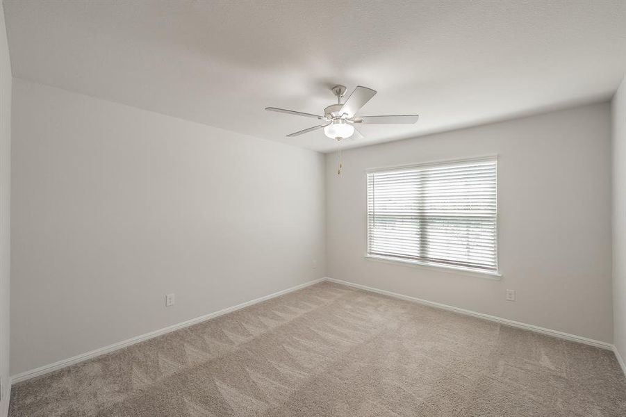 Spare room with light colored carpet and ceiling fan Spare room with light colored carpet and ceiling fan