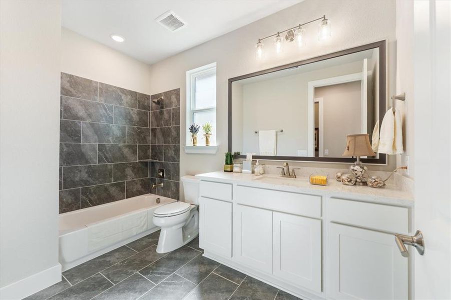 Second full bathroom with upgraded cabinetry and tile