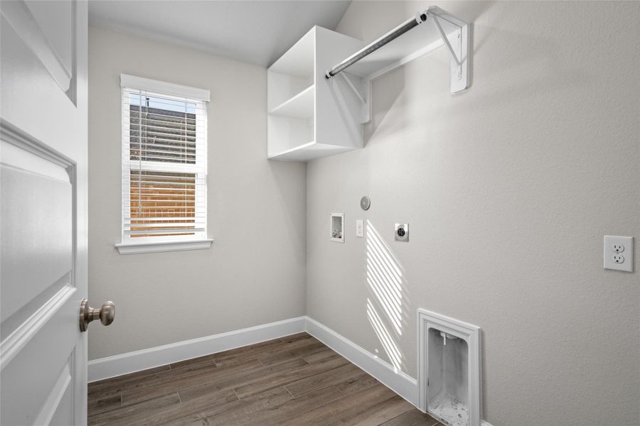 Bright Laundry Room with window and integrated storage shelving.