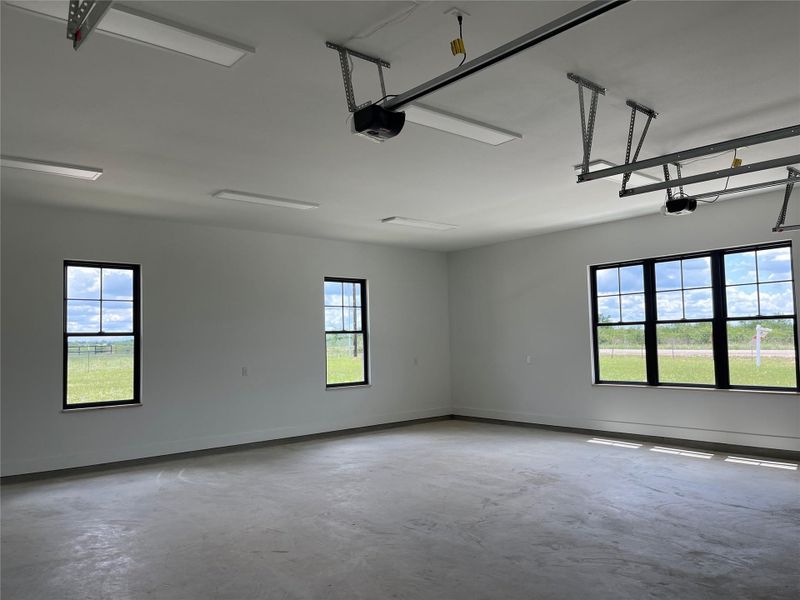 Unfurnished room with concrete floors and baseboards