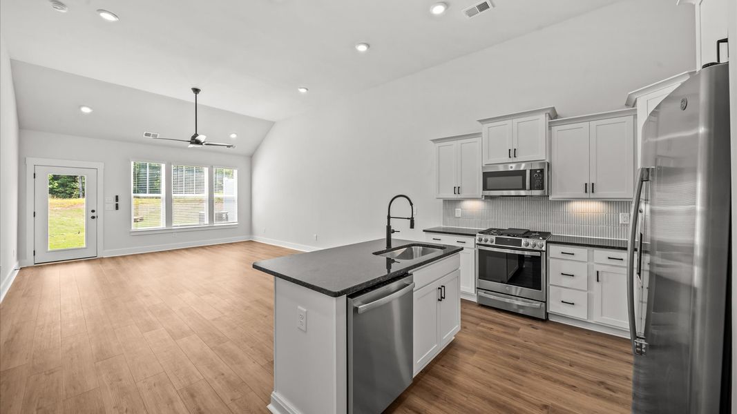 Highly functional kitchen offering a refined look and practical island at the center