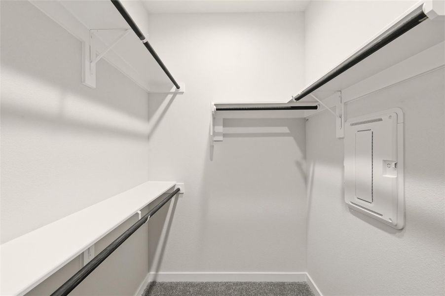 Walk in closet featuring electric panel and carpet floors