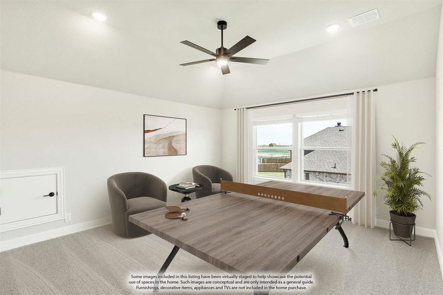 Bonus room with ping pong table, ceiling fan, carpet flooring, and two accent chairs near a window Bonus room with ping pong table, ceiling fan, carpet flooring, and two accent chairs near a window
