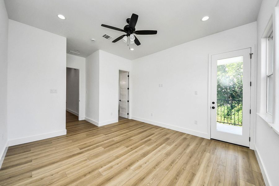 Spacious primary bedroom filled with natural light, featuring a clean, modern design and neutral tones. Generous layout offers comfort and flexibility, perfect for creating a relaxing retreat.