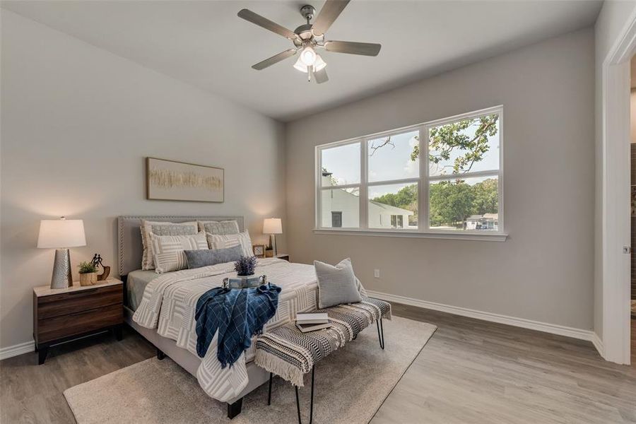 Bedroom featuring ceiling fan and wood-type flooring