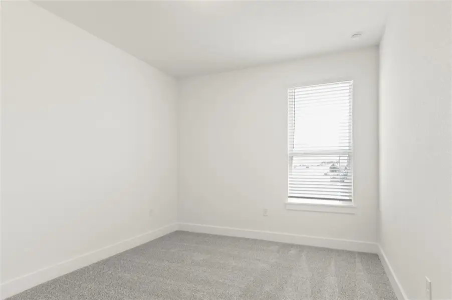 Spare room featuring light carpet