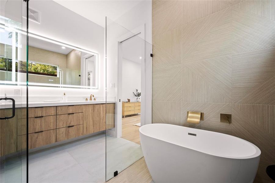 Bathroom featuring shower with separate bathtub, tile walls, vanity, and tile patterned flooring