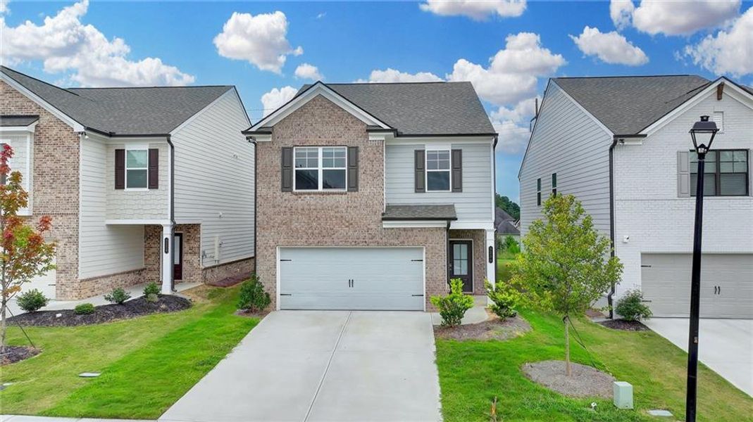Front exterior of a new home in Westgate Enclave, Loganville, GA, highlighting curb appeal (Image 1).