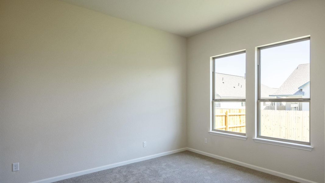 Spare room with baseboards and carpet