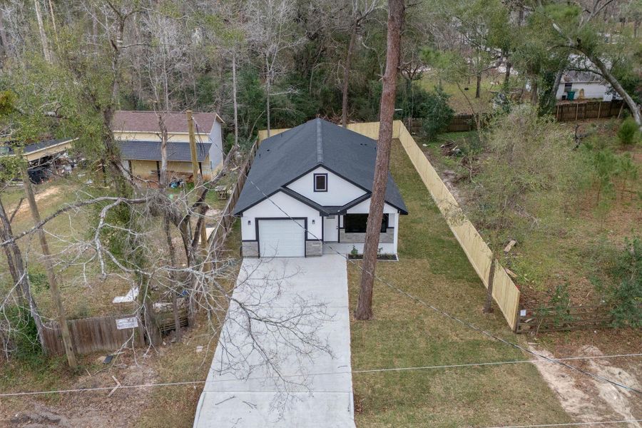 Front exterior of a new home in , Willis, TX, highlighting curb appeal (Image 22).
