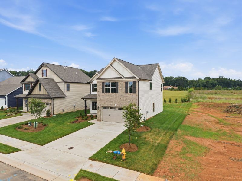 Front exterior of a new home in Sullivans Reserve, Walkertown, NC, highlighting curb appeal (Image 28). Front exterior of a new home in Sullivans Reserve, Walkertown, NC, highlighting curb appeal (Image 28).