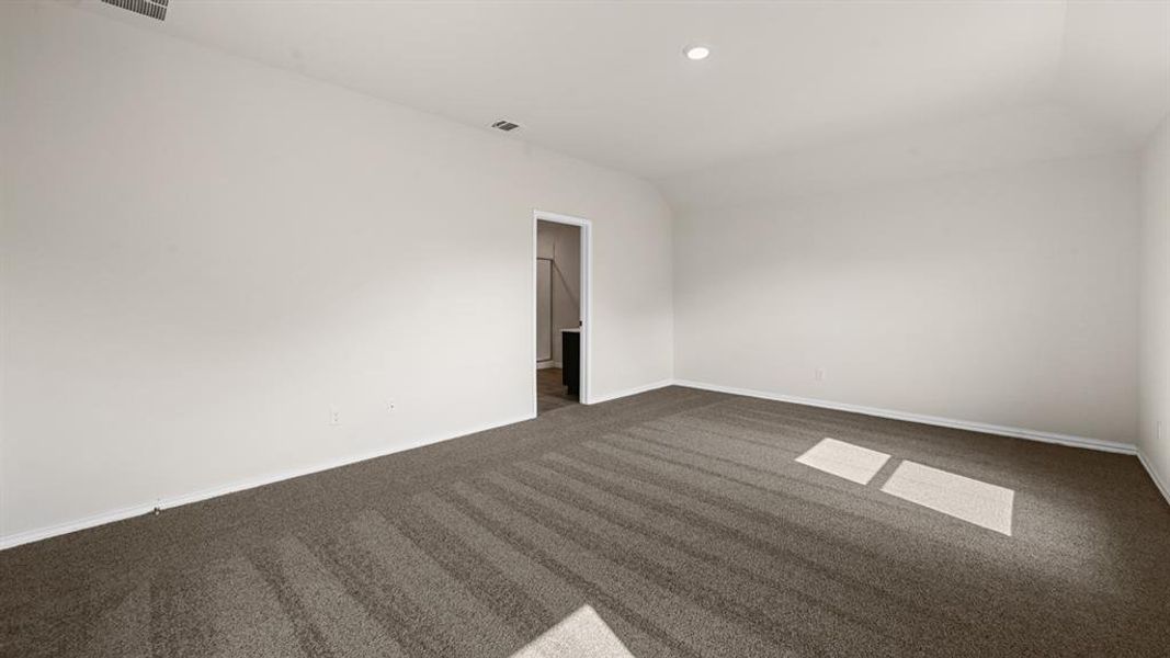 Spacious room featuring neutral carpeting, light-colored walls, recessed lighting, and white baseboards Spacious room featuring neutral carpeting, light-colored walls, recessed lighting, and white baseboards