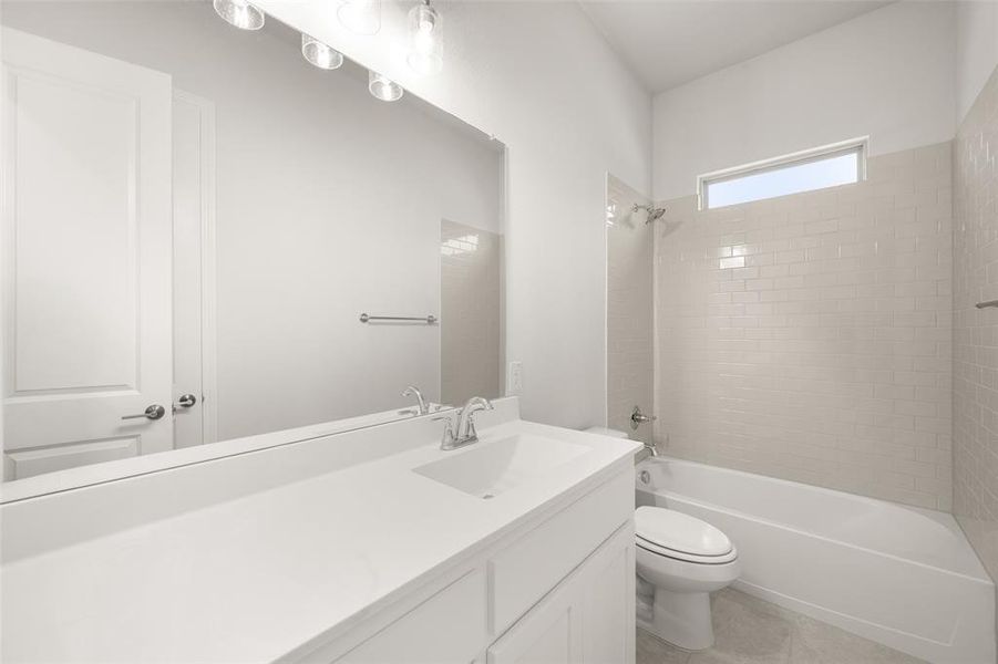 Full bath featuring vanity, bathtub / shower combination, and tile patterned floors Full bath featuring vanity, bathtub / shower combination, and tile patterned floors