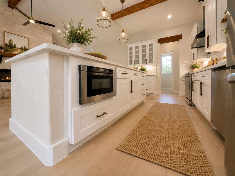 Exposed ceiling beams accent this modern culinary space with custom cabinetry and warm wood flooring.Virtual Staging. Exposed ceiling beams accent this modern culinary space with custom cabinetry and warm wood flooring.Virtual Staging.