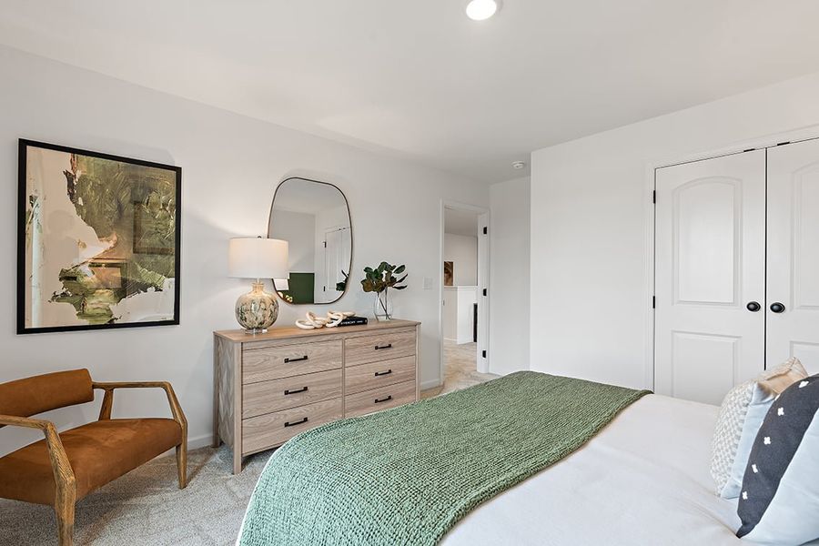 A bedroom with a bed and a mirror. A bedroom with a bed and a mirror.