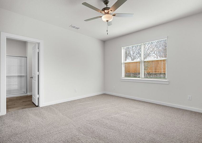 The spacious master bedroom has a window that lets in great, natural light and backyard views.