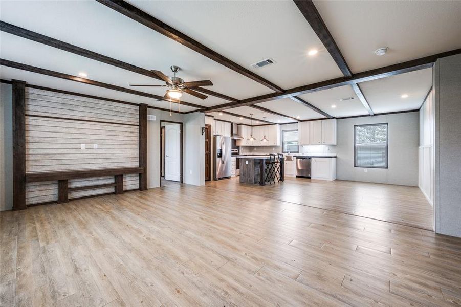 Unfurnished living room featuring a ceiling fan, light wood-style flooring, beam ceiling, and recessed lighting Unfurnished living room featuring a ceiling fan, light wood-style flooring, beam ceiling, and recessed lighting