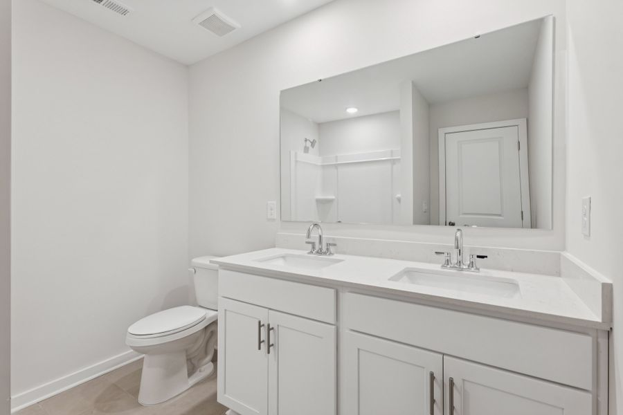 A bathroom with a large mirror. A bathroom with a large mirror.