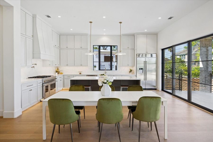 Gourmet Kitchen - features beautiful custom cabinetry and quartz counters. Custom sliding doors open to large covered back patio.