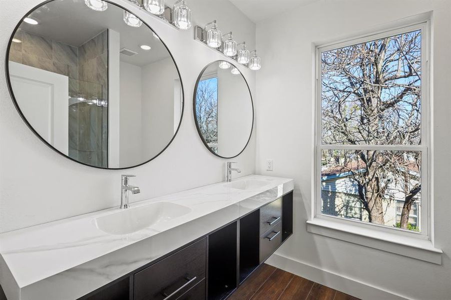 Bathroom featuring hardwood / wood-style floors, a shower, and vanity