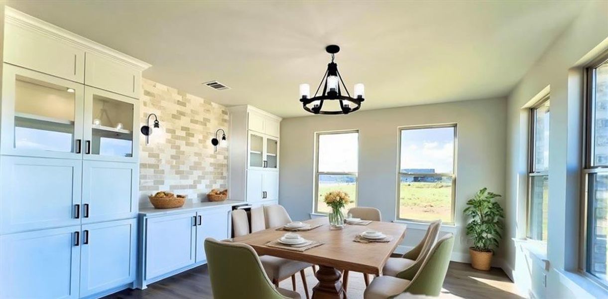 Dining area with a chandelier and dark flooring