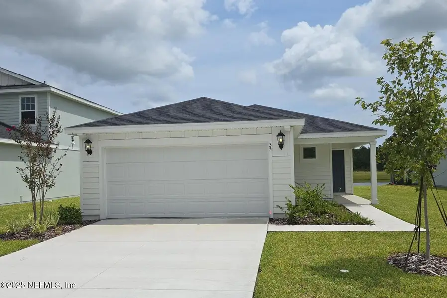 Front exterior of a new home in Flagler Village - Classic Series, Palm Coast, FL, highlighting curb appeal (Image 1). Front exterior of a new home in Flagler Village - Classic Series, Palm Coast, FL, highlighting curb appeal (Image 1).