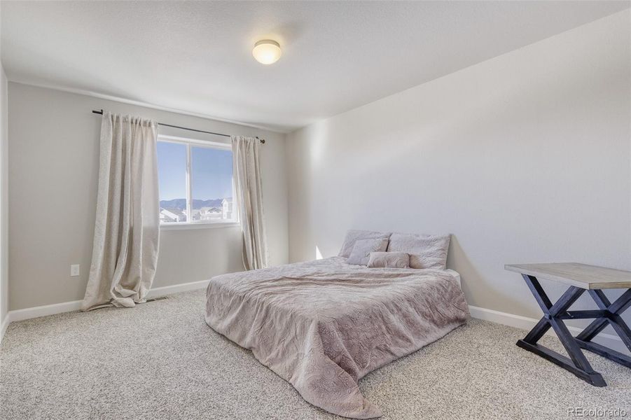 upper level second bedroom with views of the mountains