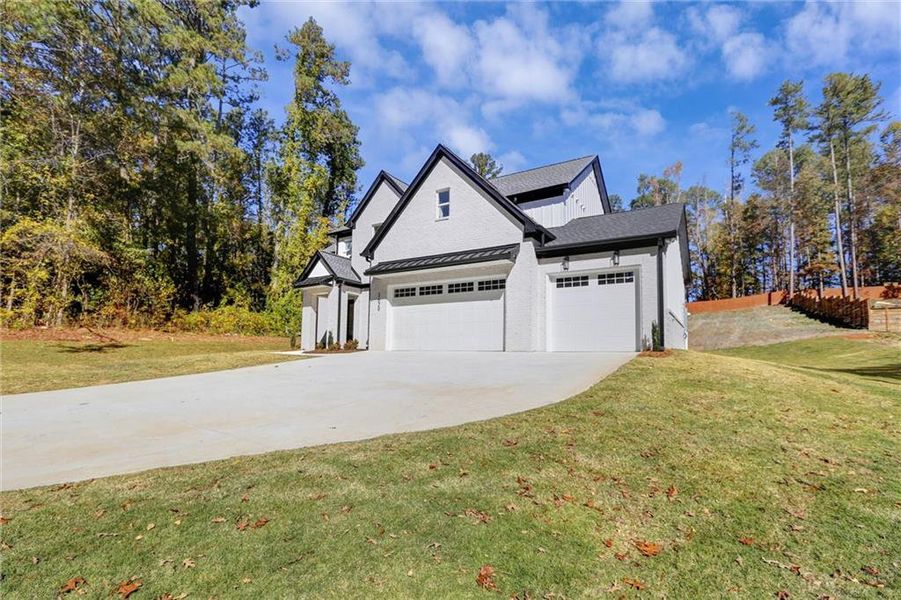 Front exterior of a new home in , Snellville, GA, highlighting curb appeal (Image 25). Front exterior of a new home in , Snellville, GA, highlighting curb appeal (Image 25).