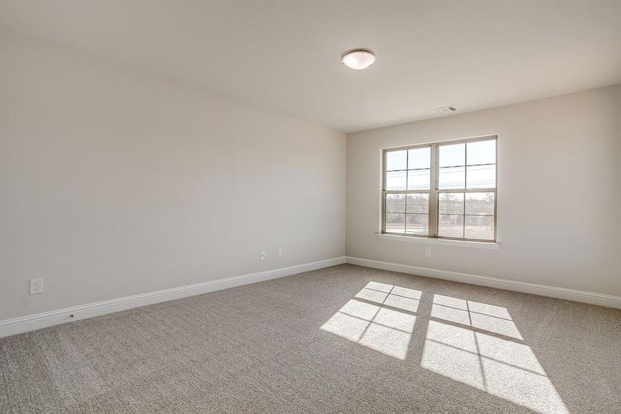 Empty room with light colored carpet