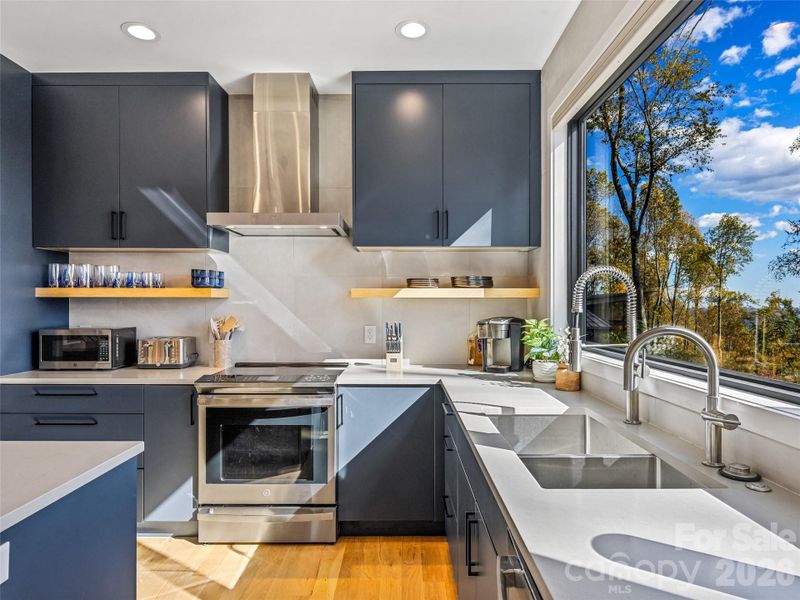 Modern cabinets, open shelving, and exquisite counters abound! Modern cabinets, open shelving, and exquisite counters abound!