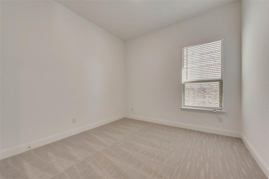 Spare room featuring light colored carpet