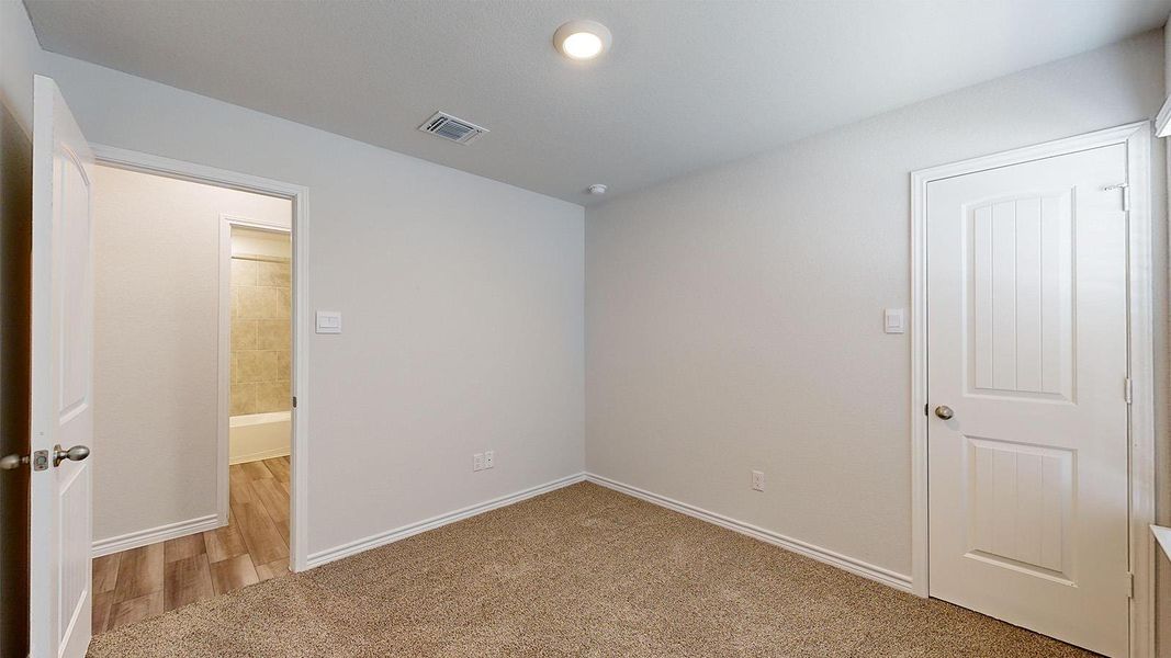 Unfurnished bedroom with light carpet and baseboards Unfurnished bedroom with light carpet and baseboards