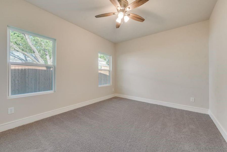 Unfurnished room with carpet floors and ceiling fan