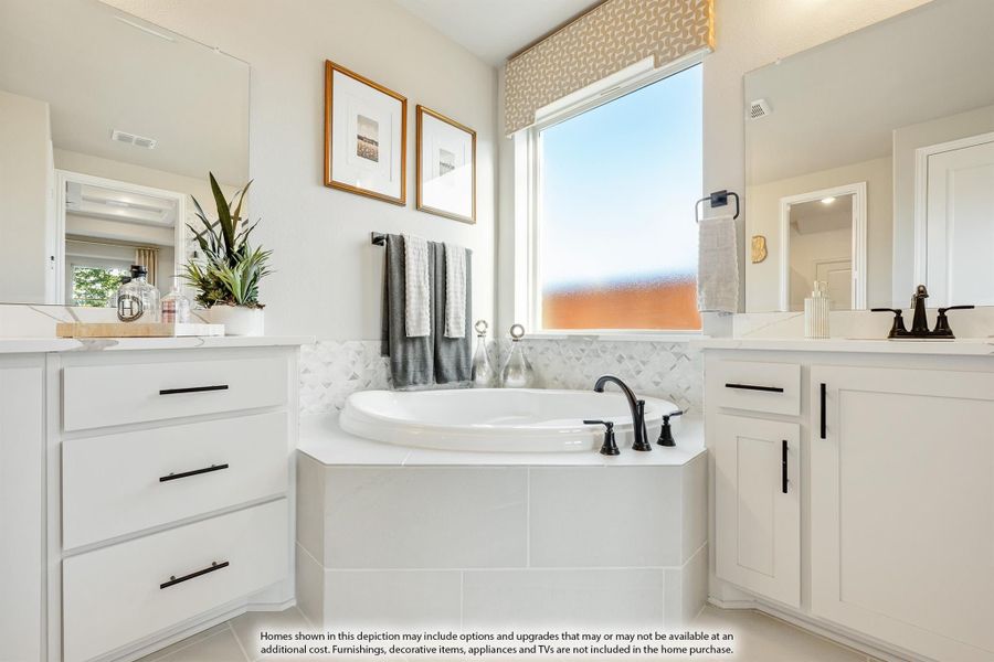 Bathroom with soaking tub, white cabinets, tile backsplash, and a window above the tub Bathroom with soaking tub, white cabinets, tile backsplash, and a window above the tub
