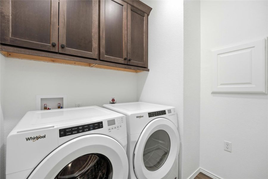 Laundry room with cabinet space and washer and clothes dryer