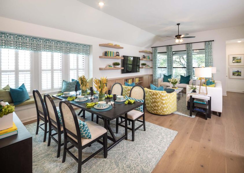 Dining space featuring ceiling fan, lofted ceiling, a healthy amount of sunlight, and wood finished floors