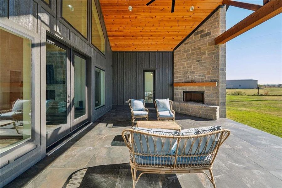 View of patio / terrace with an outdoor living space with a fireplace