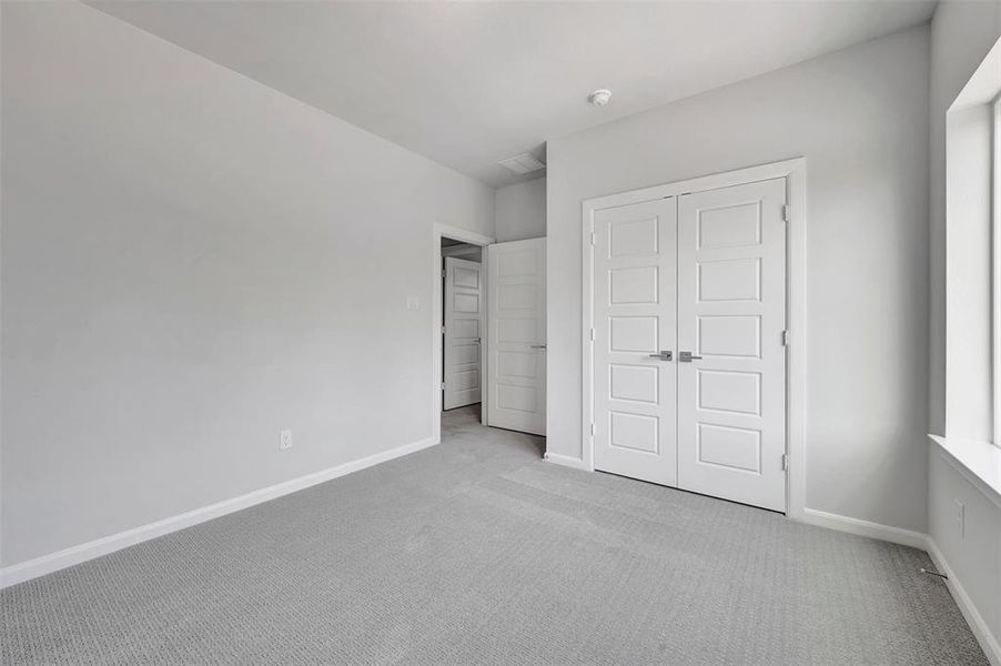 Neutral-toned interior featuring light gray carpeting and white baseboards