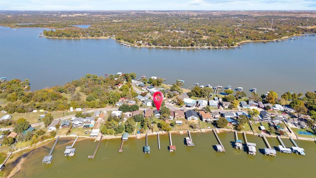 Aerial overview of property's location with a nearby body of water and nearby suburban area