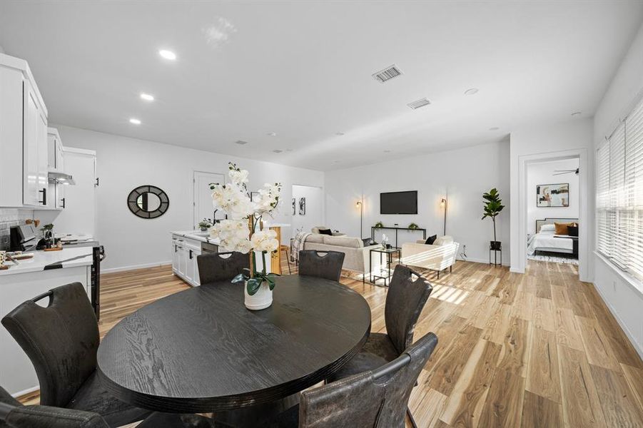 Dining space with sink and light hardwood / wood-style floors