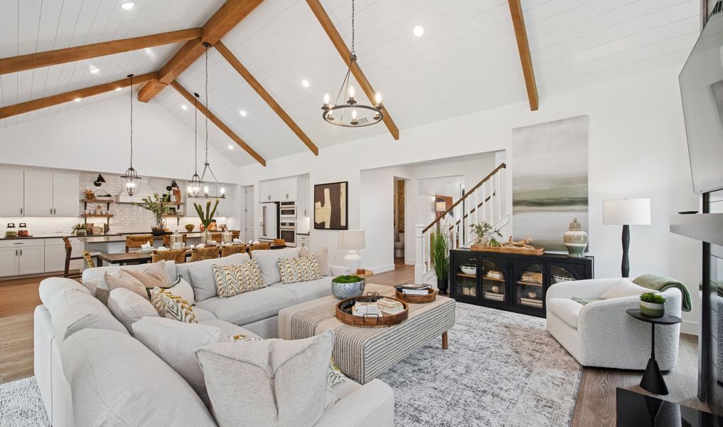 Great room with vaulted ceiling, stained ceiling beams and shiplap