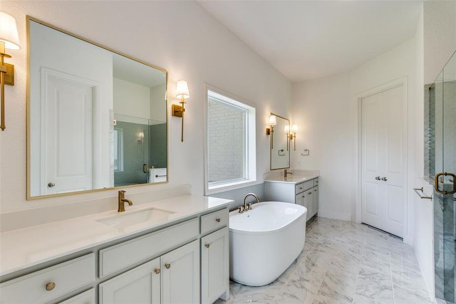 Bathroom with dual vanity, shower with separate bathtub, and tile patterned flooring