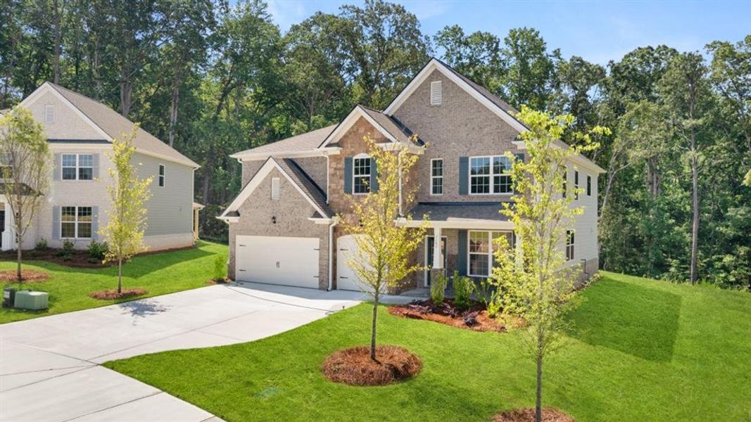 Front exterior of a new home in Holland Estates, Powder Springs, GA, highlighting curb appeal (Image 23). Front exterior of a new home in Holland Estates, Powder Springs, GA, highlighting curb appeal (Image 23).