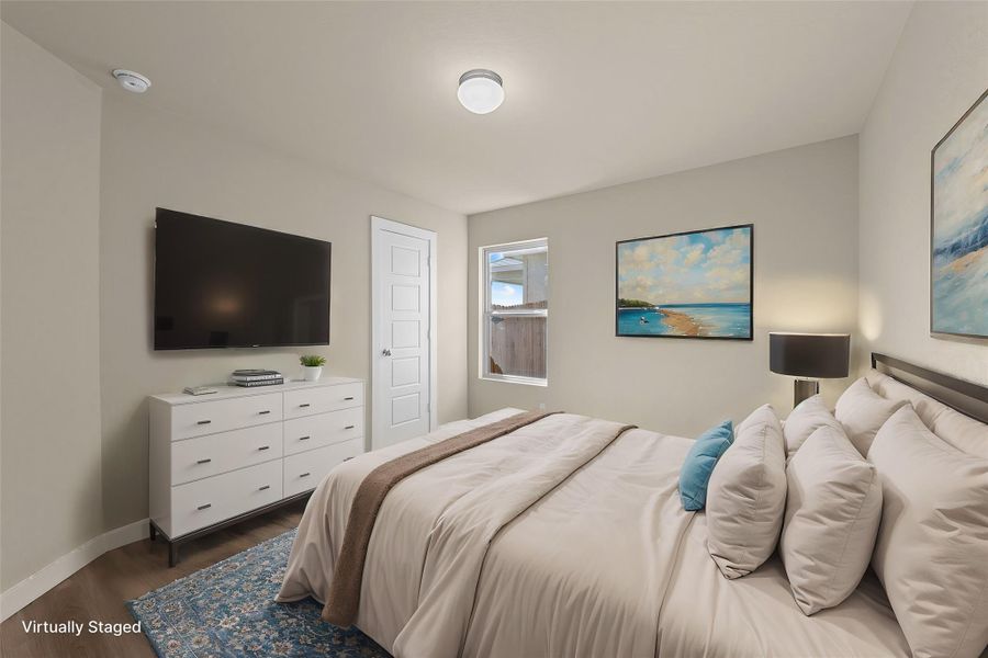Restful chamber with hardwood flooring and a bright window for natural illumination.
