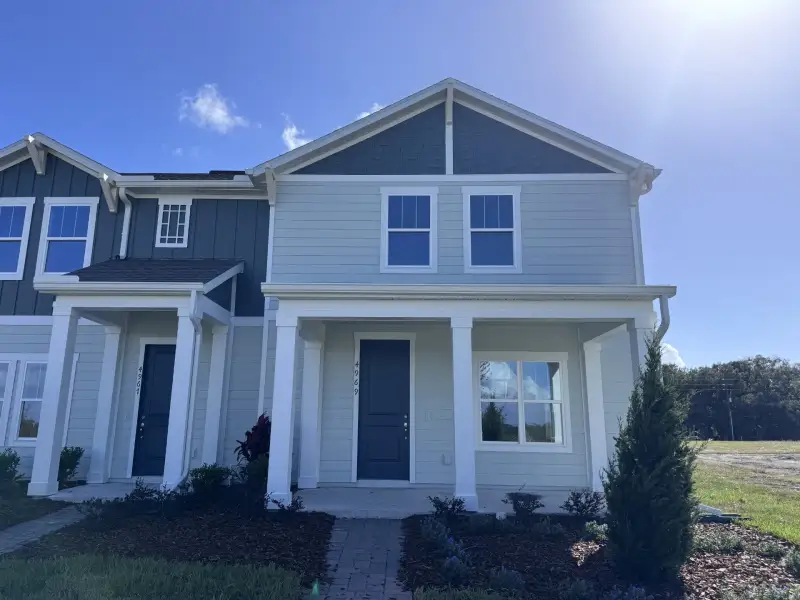 Front exterior of a new home in Whaley Grove Townhomes, St. Cloud, FL, highlighting curb appeal (Image 2). Front exterior of a new home in Whaley Grove Townhomes, St. Cloud, FL, highlighting curb appeal (Image 2).